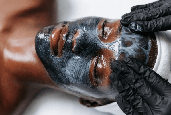 Client receiving the AB Signature Facial with a detoxifying facial mask to deep cleanse pores, refine texture, calm stressed skin, and restore hydration for a smoother, healthier-looking complexion.