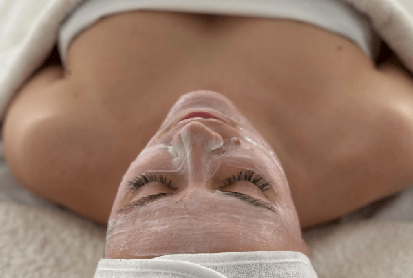 Client resting after a Microderm Facial with skin treated for exfoliation, hydration, and glow support to improve rough texture, dullness, and fine lines.
